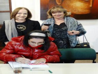 Foto de Arrieta Rangel de Abreu - Luciana do Rocio Mallon autografando o livro.
